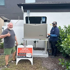Happy Suncoast Power Solutions customer with their newly installed home generator yard sign