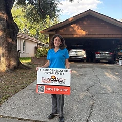 Happy Suncoast Power Solutions customer with their newly installed home generator yard sign