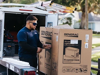 Technician unboxing a Generac standby generator