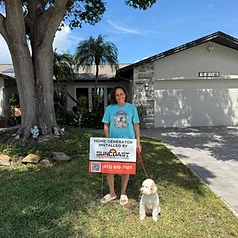 Happy Suncoast Power Solutions customer with their newly installed home generator yard sign