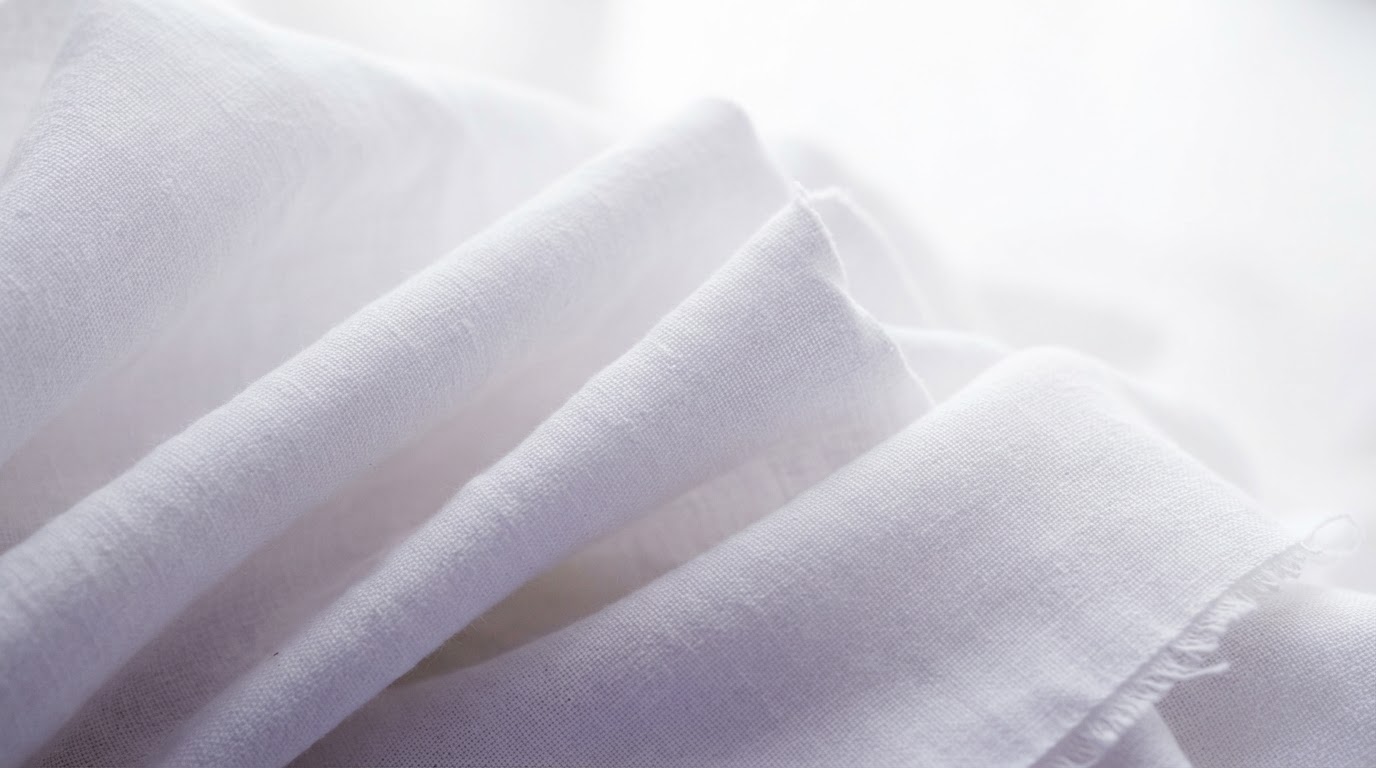Architectural folds in pristine white linen