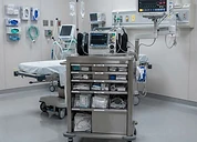 Stryker Power-PRO XT Powered Ambulance Cot — Hospital emergency resuscitation room with crash cart, defibrillator and vital signs monitor