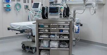 Crash Cart — Hospital emergency resuscitation room with crash cart, defibrillator and vital signs monitor