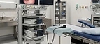 Colonoscope — Endoscopy tower with video monitor and examination table in an endoscopy procedure room