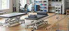 TENS Unit — Parallel bars, therapy tables and exercise equipment in a physiotherapy rehabilitation gym