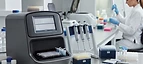 DNA Sequencer — DNA sequencing instrument with micropipettes and sample plates in a genomics laboratory