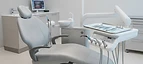 Panoramic X-Ray System — Dental treatment chair unit with overhead operating light in a modern dental clinic