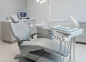 Planmeca ProMax 3D Plus CBCT Imaging Unit — Dental treatment chair unit with overhead operating light in a modern dental clinic