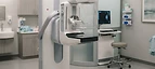 Mobile Mammography Unit — Mammography breast screening machine with compression paddle in a women's imaging room