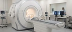 3T MRI Scanner — Magnetic resonance imaging MRI scanner bore with patient table in a radiology suite