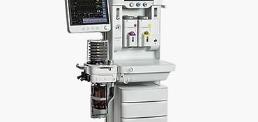 White dual-display anaesthesia workstation with patient monitor, articulating touchscreen, dual vaporizers, bellows breathing system and drawer cabinet on castor base