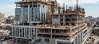 Laboratory Construction — Hospital building under construction with cranes and structural work in progress