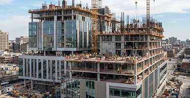 Hospital Building Construction — Hospital building under construction with cranes and structural work in progress