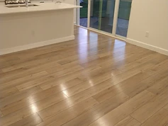 Wood-look LVP floor in a kitchen and dining area, coated with Rexpro for Lennar Homes