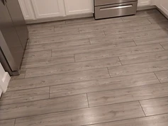 Grey luxury vinyl plank kitchen floor finished with Rexpro coating for Lennar Homes