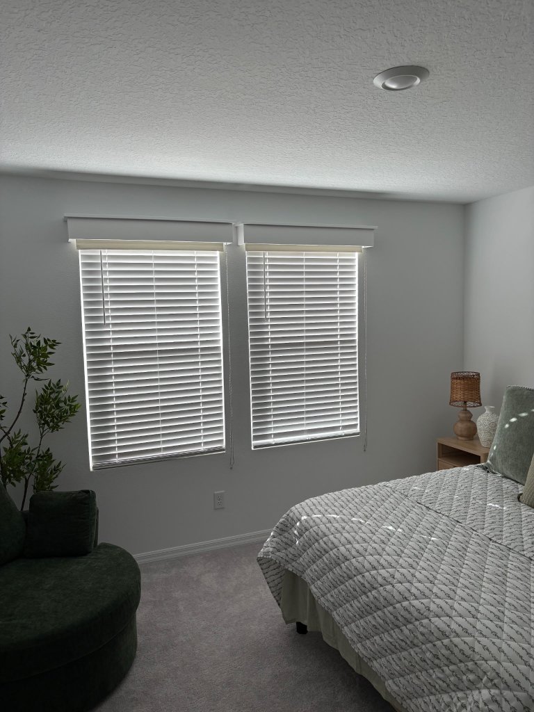 Before: bedroom with white horizontal venetian blinds