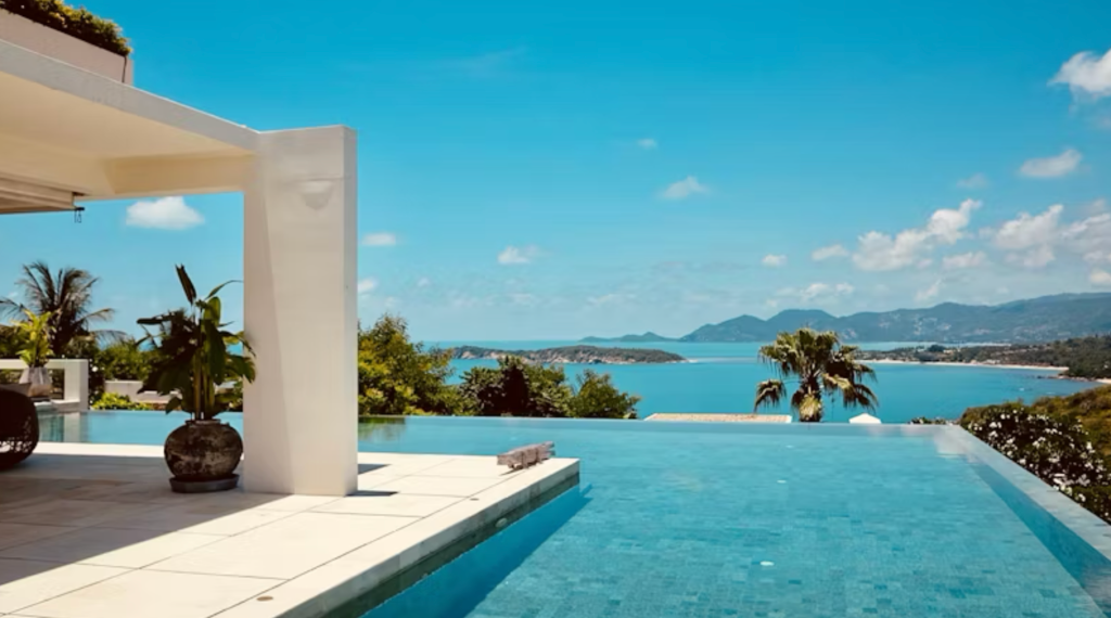 Poolside terrace overlooking the tropical bay at The Beach Samui