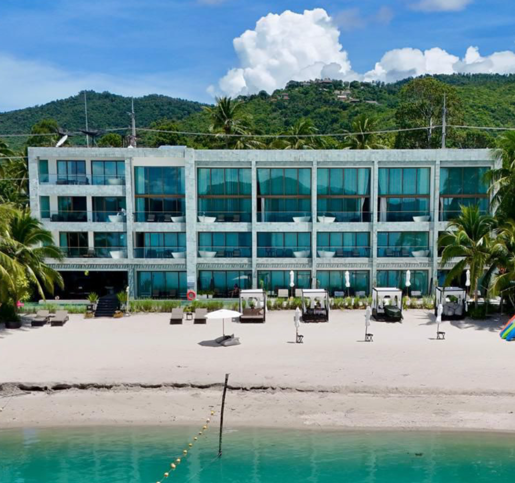 Head-on exterior of The Beach Samui hotel from the beach