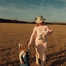 Emma with her family in a golden field