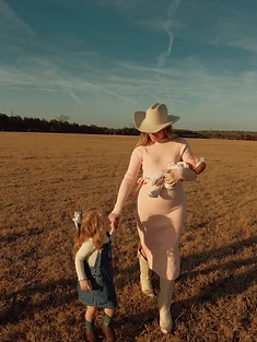 Emma with her family in a golden field