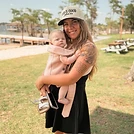 Emma wearing her GOD IS GOOD hat with her baby