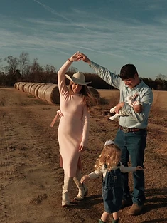 Emma and her family dancing in a field