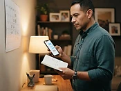 Example scene: a Latino father reviewing a custody calendar and co-parenting messages at his desk.