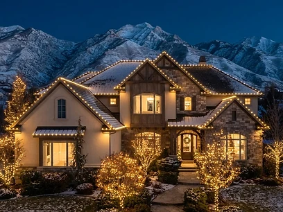 The same Salt Lake City home with LED Christmas lights glowing at dusk