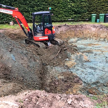 Mini excavator digging the pool excavation to depth in Sunbury-on-Thames