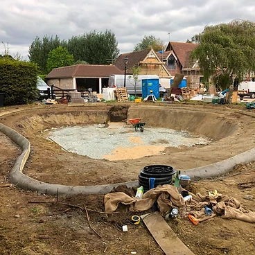Concrete pool shell with drainage pipework laid in the base in Sunbury-on-Thames