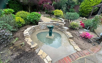 Completed ornamental pond with drystone walling in a Surrey garden