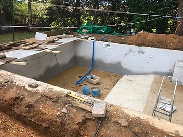 Small pool shell under construction with rendered walls in Surrey