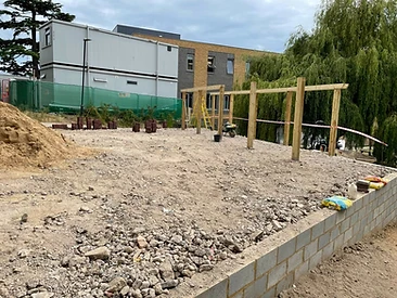 Groundworks in progress with drainage runs and compacted sub-base in Surrey