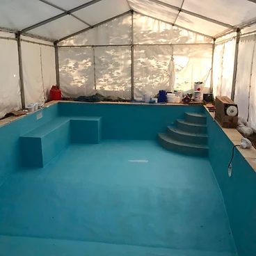 Completed small swimming pool with blue liner and brick steps in Sunbury-on-Thames