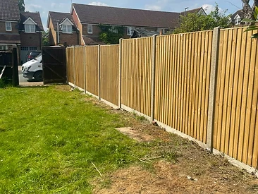 Close-board featheredge fence on concrete posts along a Surrey boundary