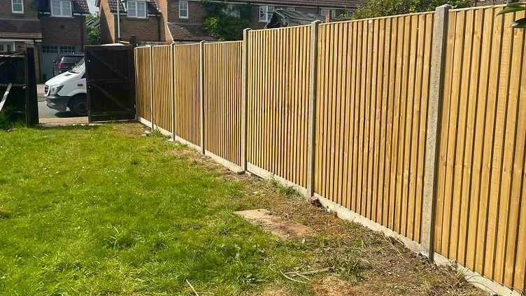 Close-board featheredge fence on concrete posts along a Surrey boundary