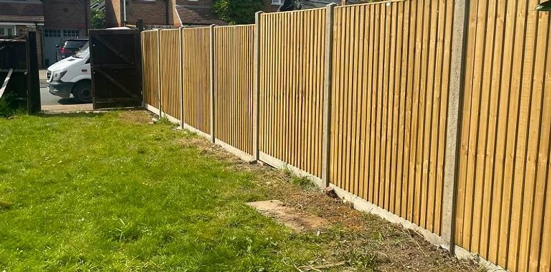 Close-board featheredge fence on concrete posts along a Surrey boundary