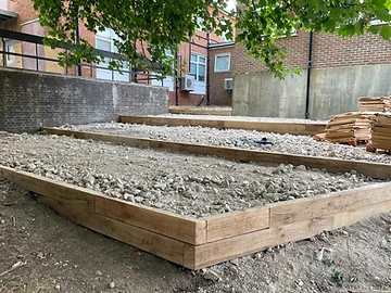 Sleeper steps built into a sloped garden with gravel treads, Surrey