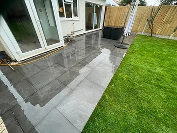 Large-format porcelain slabs being laid on a mortar bed, Surrey