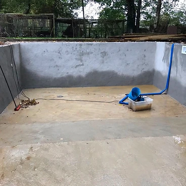 Rendered pool walls with inlet pipework and light fitting in Sunbury-on-Thames