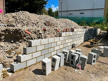 Brick and block retaining wall being built with drainage behind, Surrey
