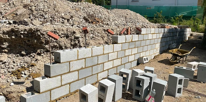 Block and brick retaining wall under construction with drainage in Surrey
