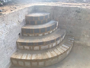 Curved brickwork steps built inside a new pool shell in Surrey