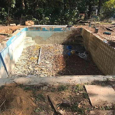 Existing pool shell stripped back to bare concrete for refurbishment in Sunbury-on-Thames