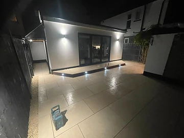 Paved entertaining area with a timber pergola and porcelain floor, Surrey