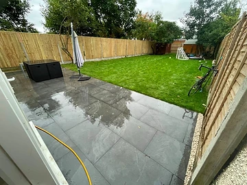Porcelain patio meeting a new lawn and close-board fence, Surrey