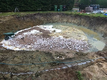 Existing pool interior with worn render before refurbishment in Surrey