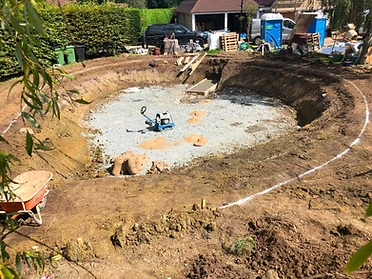 Excavated pool shell with compacted blinding layer before blockwork, Surrey
