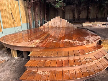 Circular wooden deck with tiered steps and glossy oiled hardwood surface in Surrey