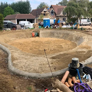 Large oval pool excavation with concrete ring beam cast in Sunbury-on-Thames